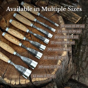 May include: A set of seven wood chisels with light brown wooden handles and metal blades, arranged in a row. The text "Available in Multiple Sizes" is displayed, along with labels for 10 mm (0.39 in), 15 mm (0.59 in), 20 mm (0.78 in), 25 mm (0.98 in), 30 mm (1.18 in), 35 mm (1.37 in), 40 mm (1.57 in), and 45 mm (1.77 in).
