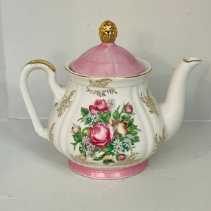 Hermosa tetera vintage de porcelana fina Royal Crown con diseño floral rosa y detalles dorados