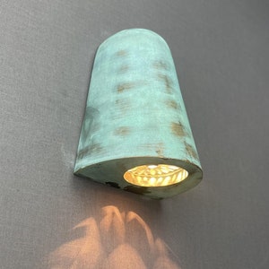 Art deco wall sconce with verdigris green patina - handcrafted brass or copper wall light - artisan light fixture with unique shadow pattern