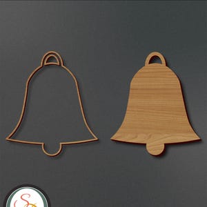 May include: Two wooden bells, one with a solid outline and the other with a cutout design. The bells are on a dark brown background.