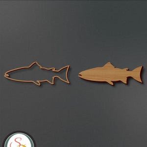 May include: Two wooden cutouts of a salmon fish. One cutout is solid wood, the other is an outline. The word "Salmon" is at the top of the image.