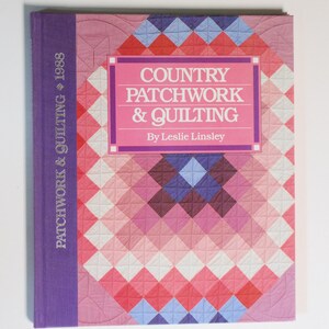May include: A hardcover book titled "Country Patchwork & Quilting" by Leslie Linsley. The cover features a patchwork design in shades of pink, red, white, and blue. The spine is purple with the text "Patchwork & Quilting 1988".