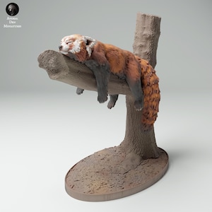 May include: A red panda figurine sleeping on a tree branch. The figurine is made of painted resin and is part of a collection of animal figurines.