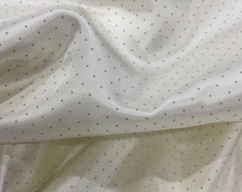 May include: White fabric with a subtle texture and small, evenly spaced gold dots.