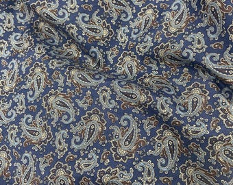 May include: Blue paisley fabric with a white and brown paisley pattern.