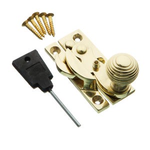May include: A brass window sash lock with a decorative knob, a black key, and gold screws. The rectangular lock has a pivoting arm. The knob has a ridged design. Screws and key are included.