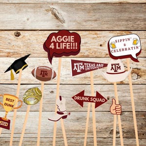 May include: A set of 10 photo booth props featuring Texas A&M University themes. The props include a graduation cap, a football, a ring, a trophy, a cowboy boot, a thumbs up hand, a speech bubble with the text "Aggie 4 Life!!!", a pennant with the text "Texas A&M University", a cowboy hat with the text "AM", and a speech bubble with the text "Sippin' & Celebratin'".