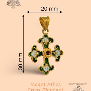 May include: A gold-colored cross pendant, 30 mm in length and 20 mm wide, with green and white enamel detailing. The center features a small, round, red gemstone. The text "Mount Athos Cross / Pendant" is visible.