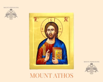 May include: Hand-painted icon of Jesus Christ holding a book. The icon is framed in gold and has a red and blue background. The text "IC XC" is written in the top corners of the icon.