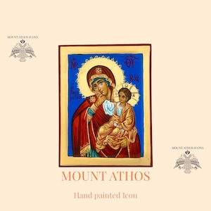 Può includere: Icona dipinta a mano della Vergine Maria e del bambino Gesù. L'icona è su uno sfondo di legno con una cornice dorata. La Vergine Maria indossa una veste rossa e un mantello blu. Tiene il bambino Gesù tra le braccia. Il bambino Gesù indossa una veste gialla. L'icona è un'icona ortodossa tradizionale.