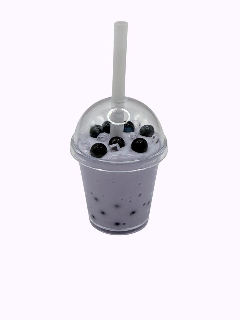 Lavender glossy slime in a clear jar labeled “Taro Boba,” topped with realistic ice cube charms, black boba ball charms, and a mini boba cup. Soft, thick texture and smooth finish, perfect for ASMR and bubble pops. Suitable for slime enthusiasts, collectors, and sensory play lovers.