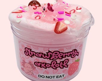May include: Pink slime in a clear plastic container with a pink and white label that says "Strawberry axolotl" and "Do Not Eat". The slime is topped with a pink axolotl charm, strawberries, and sprinkles.