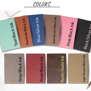 May include: A selection of eight different colored notebooks with various ink colors. The notebooks are arranged in two rows of four. The colors include teal, rawhide, blue, dark brown, pink, black, gray, rose, rustic, and light brown.