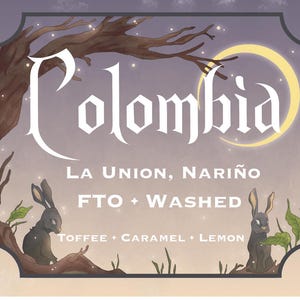May include: A vintage-style label with the word "Colombia" in a stylized font, along with the text "La Union, Nariño" and "FTO + Washed". The label also features a description of the coffee's flavor profile: "Toffee + Caramel + Lemon". The label is illustrated with two black rabbits sitting on a branch with leaves.