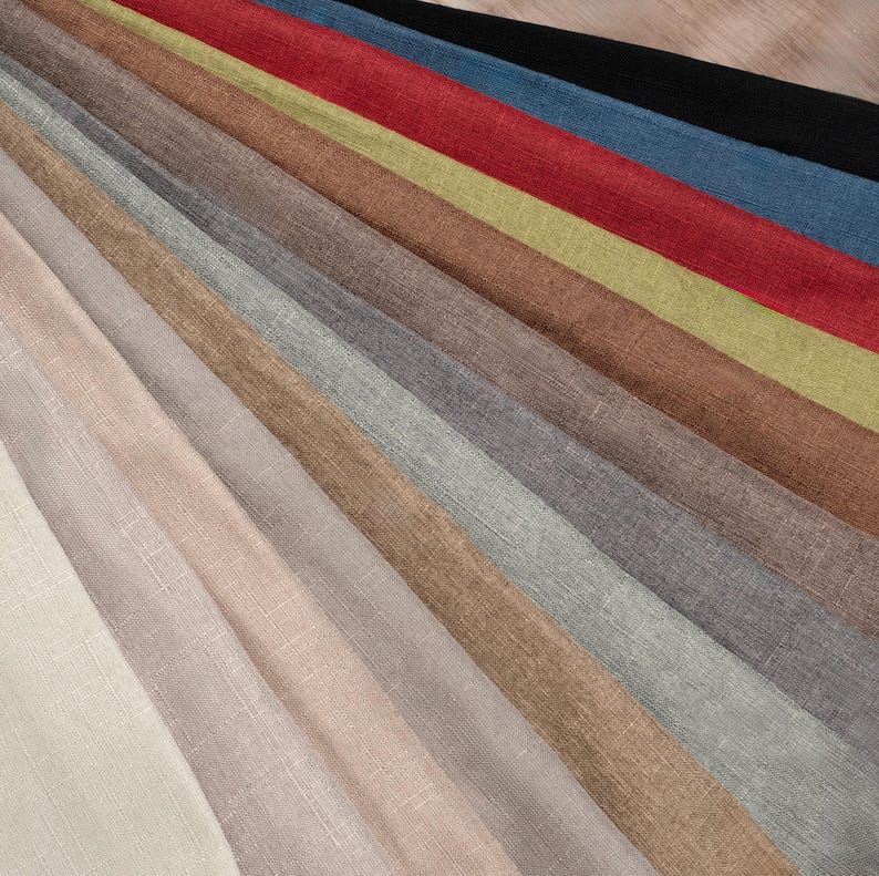May include: A selection of fabric swatches in various colours and textures, including beige, brown, grey, and red. The swatches are arranged in a fan shape, with the lightest colours at the top and the darkest colours at the bottom.