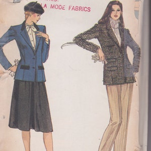May include: A Vogue sewing pattern envelope 7808 featuring illustrations of two outfits. One shows a blue blazer with black trim, a white blouse, and a black skirt. The other shows a plaid blazer, a white turtleneck, and tan trousers. Text reads PATTERNS CANNOT BE EXCHANGED OR RETURNED.