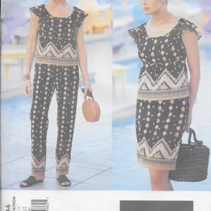 May include: A black and gold patterned top and pants set, and a matching skirt and top set. The outfits feature a geometric design with a decorative border. The image also includes the text "ANNA SUI" and pattern details.