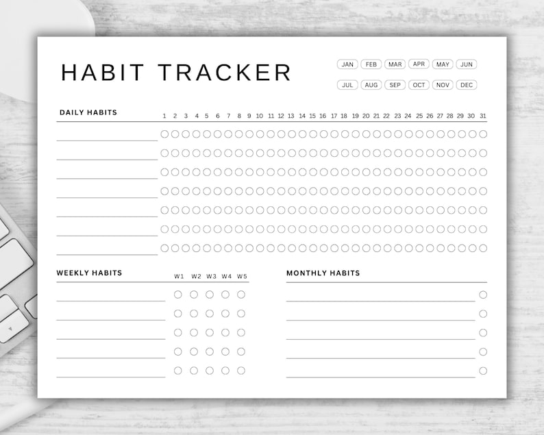 May include: A black and white printable habit tracker with sections for daily, weekly, and monthly habits. The tracker includes a calendar with the months of the year and numbered days.