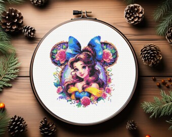 May include: A cross-stitch embroidery pattern featuring Belle from Beauty and the Beast, with a blue bow and floral accents, in a round embroidery hoop.