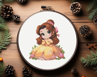 May include: A cross-stitch embroidery hoop with a white background featuring a cartoon image of Belle from Beauty and the Beast. Belle is wearing a yellow dress with a pink sash and has brown hair. She is surrounded by pink roses and green leaves.