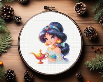 May include: A cross-stitch embroidery hoop with a colorful image of a cartoon princess holding a golden lamp. The princess has long dark hair, blue eyes, and is wearing a blue and green outfit.