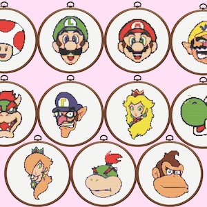 May include: A set of 10 cross-stitch patterns featuring characters from the Super Mario Bros. video game franchise. The patterns include Mario, Luigi, Peach, Bowser, Yoshi, Donkey Kong, Wario, Waluigi, Toad, and a Shy Guy.