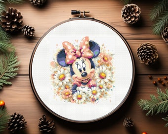 May include: A cross-stitch embroidery hoop with a colorful image of Minnie Mouse surrounded by white daisies. Minnie Mouse is wearing a pink bow with white polka dots and a pink dress.