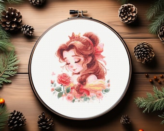May include: Cross-stitch embroidery hoop with a white background featuring a cartoon illustration of Belle from Beauty and the Beast. Belle is wearing a yellow dress and a crown. She is holding a red rose and surrounded by pink roses.