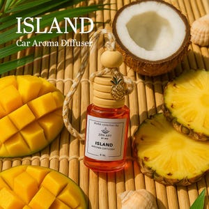 May include: An "ISLAND" car aroma diffuser with a wooden cap and a pineapple charm, surrounded by mango and pineapple slices, and a coconut half. The diffuser's label reads "ISLAND AROMA DIFFUSER 8 ML".