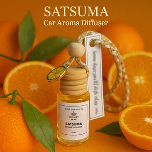 May include: Car aroma diffuser labelled "SATSUMA" with a wooden cap and a citrus charm. The bottle contains a yellow liquid, set against a backdrop of orange slices and green leaves. The text "Car Aroma Diffuser" is above the bottle.