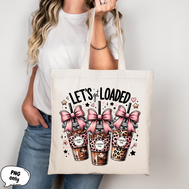 May include: A white canvas tote bag with the text "LET'S get LOADED" in black. Three pink bow-topped cups with the text "Loaded Tea" are depicted in front of the text. The cups have a leopard print design.