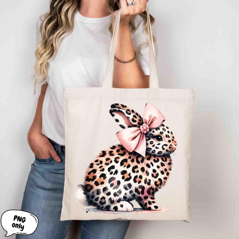 May include: A white canvas tote bag with a pink bow and a leopard print bunny rabbit illustration.