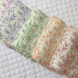 May include: Four fabric swatches with a floral pattern. The swatches are arranged in a stack, with the top swatch being a light pink floral pattern, followed by a green floral pattern, then an orange floral pattern, and finally a red floral pattern.