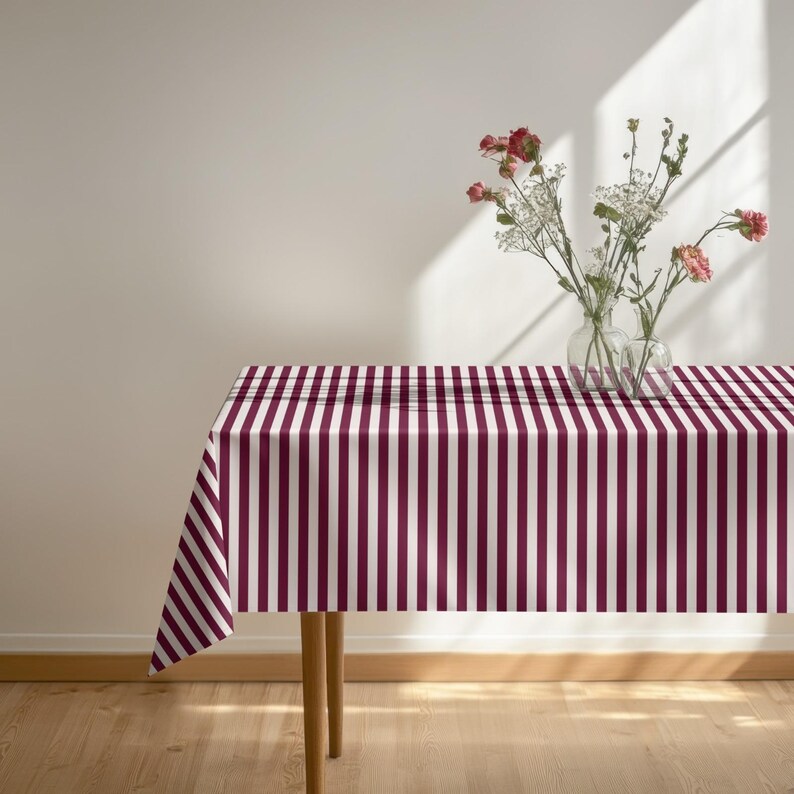 This burgundy stripe tablecloth is both practical and decorative.
Designed to bring warmth, style, and timeless appeal to any dining space.