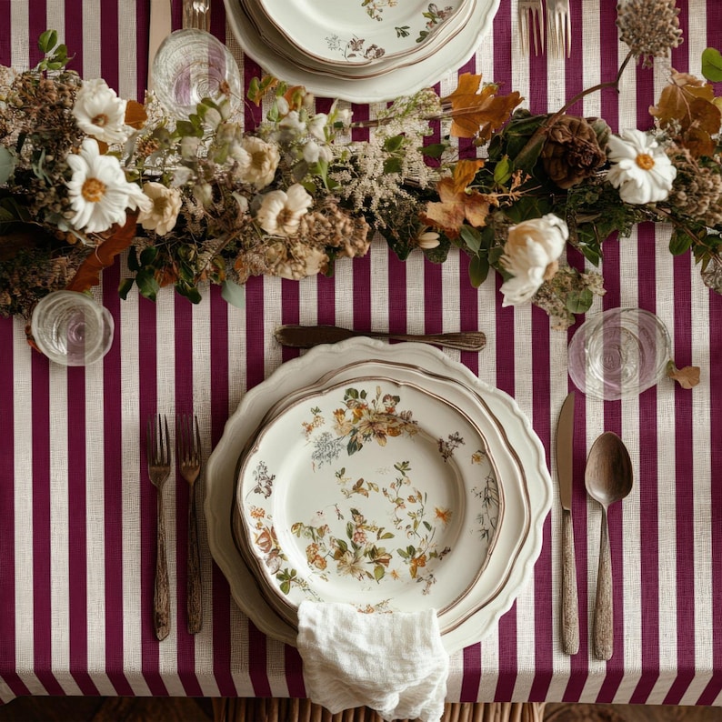 This burgundy stripe tablecloth adds a warm and classic touch to your dining table.
Its vintage striped pattern creates a cozy and inviting atmosphere.