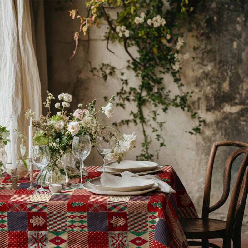 Rustic Christmas table linen with red, green, and cream tones, adding warmth to your winter dining decor.