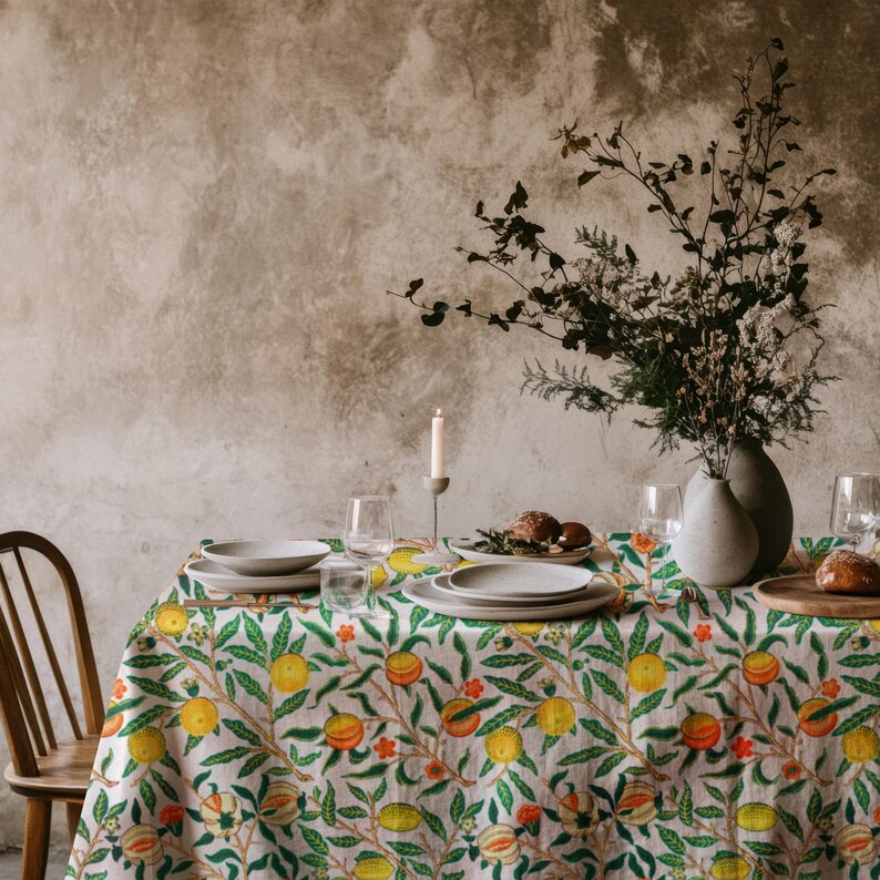 Soft fabric tablecloth with a cheerful lemon and botanical print, perfect for summer gatherings.