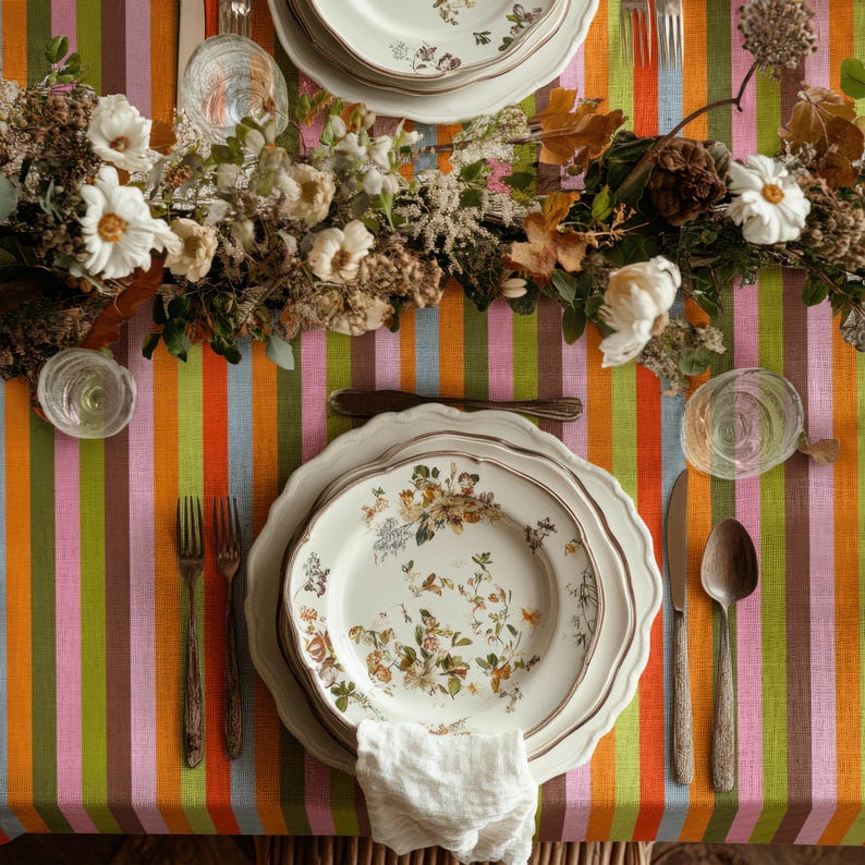 Modern party table setup featuring a multicolor striped table linen. The lively design enhances celebrations and joyful moments. Perfect for birthdays and special events.