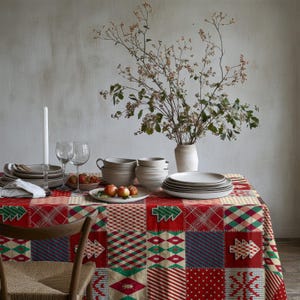 A festive winter tablecloth decorated with patchwork details, snowflakes, and Christmas trees.