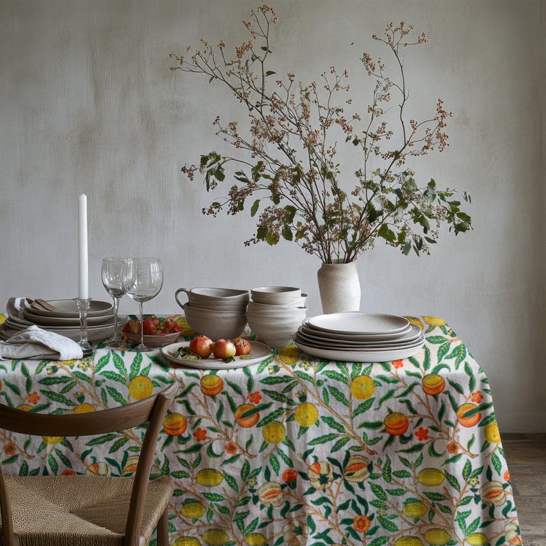 Farmhouse-style tablecloth featuring a bright lemon and greenery design on a neutral background.