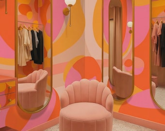 May include: A light pink velvet chair with a scalloped backrest and a cylindrical base, positioned in a room with orange and pink curved wall patterns, gold-framed oval mirrors, and wall-mounted globe lights above a speckled floor.