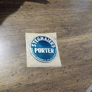 May include: A Stegmaier's Porter sticker in a clear plastic sleeve. The sticker is round with a blue and white design. The text "STEGMAIER'S PORTER" is printed on the sticker.
