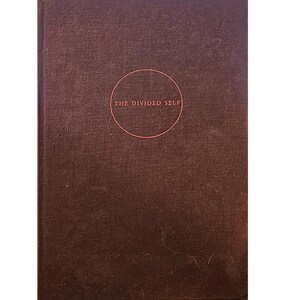 May include: A brown book with the title "The Divided Self" printed in a circle on the front cover.
