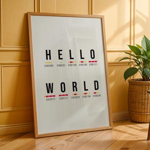 May include: A rectangular framed wall art piece featuring the black text HELLO WORLD in a sans-serif font. Below each letter is a corresponding sequence of red and yellow dots and dashes, followed by a row of binary code numbers in black.