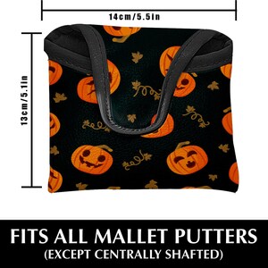 May include: Black mallet putter cover with a repeating pattern of orange jack-o'-lanterns and gold vines. The cover is 5.5 inches wide and 5.1 inches tall. Text at the bottom reads "FITS ALL MALLET PUTTERS (EXCEPT CENTRALLY SHAFTED)".