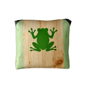 May include: Square decorative pillow featuring a green frog silhouette on a faux wood grain design. The pillow has light green leather-like sides and black corners. The frog is centered on the pillow.