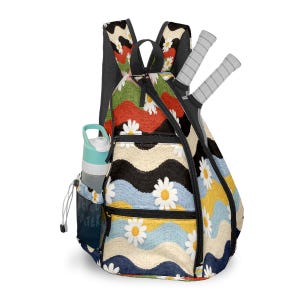 May include: A daisy-patterned backpack with a water bottle in the side pocket and two tennis rackets. The backpack features a colorful wave design with white daisies on a black, blue, yellow, and red background. The water bottle is light blue and gray.
