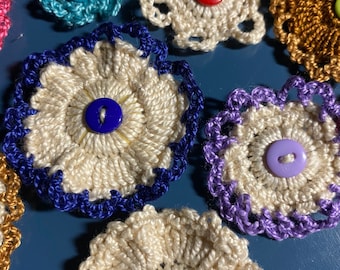 Set of 6 crocheted flowers, various colors, sizes, and styles.