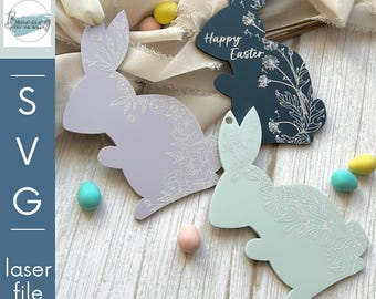 May include: Three laser cut bunny shapes with floral designs. The bunnies are in shades of purple, blue, and green. The blue bunny has the text "Happy Easter" on it.