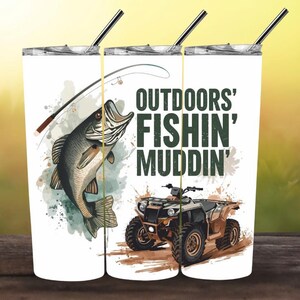 May include: White tumbler with a black straw. The design includes a leaping fish, fishing rod, and an ATV. Text reads "OUTDOORS' FISHIN' MUDDIN'". The graphic is in green, brown, and black.